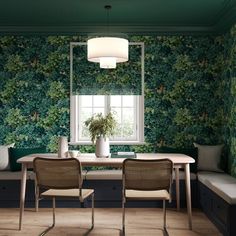 a dining room with green wallpaper and chairs