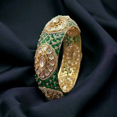 Emerald Polki Bangle, a Sabyasachi-inspired masterpiece. The vibrant Green Kundan stones and Moissanite Polki detailing enhance the regal charm of this bracelet. Crafted with precision, the Uncut Polki Jewelry captures the essence of traditional allure. These high-quality Polki Kada Bangles showcase a blend of sophistication and luxury, making a statement of grace and elegance that complements both traditional and contemporary ensembles. *𝐏𝐑𝐎𝐃𝐔𝐂𝐓 𝐃𝐄𝐓𝐀𝐈𝐋* * Material: Brass * Plating: Gold Plated * Stone: Semi Precious Kundan, Polki & Emerald.  *𝐃𝐈𝐌𝐄𝐍𝐒𝐈𝐎𝐍𝐒* *  Openable *𝐒𝐇𝐈𝐏𝐏𝐈𝐍𝐆 𝐏𝐎𝐋𝐈𝐂𝐘* * Shipping: worldwide from India. * Free shipping: All our products have a free standard shipping policy. So, choosing to shop with us is always free! * The average standa Polki Bangles Uncut Diamond, Polki Kada, Kundan Kada, Polki Bracelet, Kada Bangles, Gold Kada, Sabyasachi Jewelry, Kundan Bangles, Bangle Gold