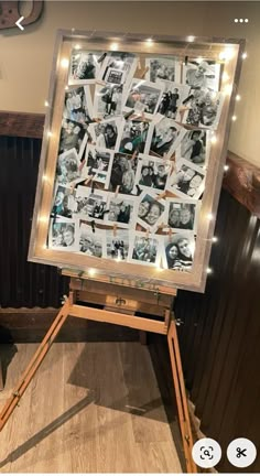 an easel with pictures on it in front of a wall