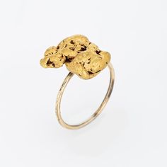 Originally an antique Victorian era stick pin (circa 1880s to 1900s), the natural gold nugget is crafted in 14 karat yellow gold.  The ring is mounted with the original stick pin. Our jeweller rounded the stick pin into a slim band for the finger. The natural mined from the earth gold nugget is substantial in size, measuring 15mm x 13mm (0.59 x 0.15 inches). The nugget has a lovely rich buttery patina with a softness to the touch.    The ring is in very good condition. We have not cleaned it in Heirloom 14k Gold Nugget Ring, Heirloom 14k Gold Jewelry, Gold Hammered Nugget Rings, Yellow Gold Nugget Brass Jewelry, Heirloom Gold Nugget Ring, Alligator Ring, Wedding Ring Guard, Gold Nugget Ring, Natural Gold Nugget