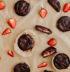 chocolate covered strawberries and other pastries on wax paper