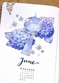 an open planner with blue flowers on it and the date for june written in ink