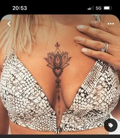 a woman's chest with a tattoo on it