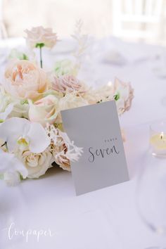 a bouquet of flowers on a table with a sign that says, thank sren