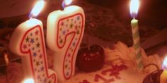 a birthday cake with lit candles on it and the number twenty five written in frosting