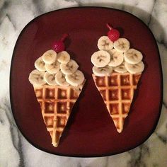 two waffles with bananas and strawberries on them are sitting on a plate