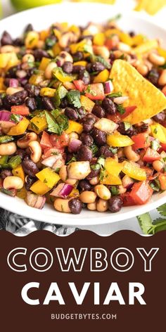 a white bowl filled with black - eyed beans and mango salsa on top of a table