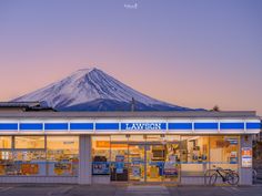 a store front with a mountain in the background