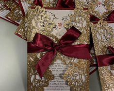 some red and gold cards with bows on them