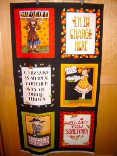 a wall hanging on the side of a door with some pictures and words in it