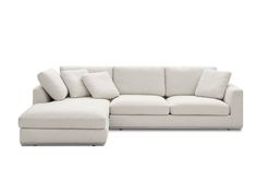 a white sectional couch with pillows on it's back and the seat folded out