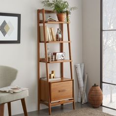 a living room with a book shelf and chair next to a large glass door window