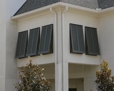 a white house with black shutters on the windows