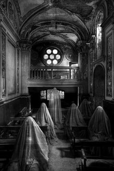 an abandoned church with cloth draped over the pews