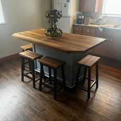 a kitchen island with two stools in it