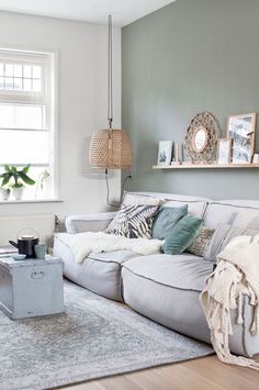 a living room filled with furniture next to a white rug on top of a hard wood floor