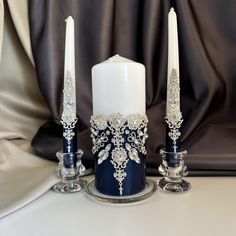 two candles are sitting next to each other on a table