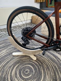 there is a bike that has been placed on the floor with it's front wheel still attached