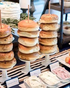 a table topped with lots of different types of cakes and donuts covered in frosting