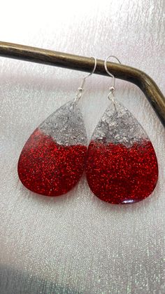 red and silver glitter tear earrings on a white background