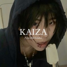 a man in a black hoodie is eating an ice cream lollypop with the words kaja on it