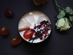 a bowl filled with food next to some flowers