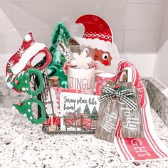 a kitchen counter topped with lots of christmas decorations and decorating items on top of it