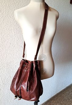 Vintage bucket bag made of brown soft leather, unlined, abjustable strap, in very good condition. Measurements: width - 36 cm / 14.2'' /when drawstring is open/ height - 28 cm / 11'' depth - 17 cm / 6.8'' Brown Bucket Hobo Bag With Adjustable Strap, Vintage Bucket Bag With Adjustable Strap, Vintage Brown Hobo Bag In Pouch Shape, Vintage Brown Hobo Bag Pouch Style, Vintage Brown Pouch Hobo Bag, Retro Brown Hobo Bag With Adjustable Strap, Vintage Brown Bucket Bag, Vintage Leather Bucket Bag With Adjustable Strap, Brown Leather-lined Bucket Hobo Bag