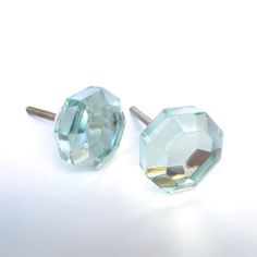 two blue crystal knobs sitting next to each other