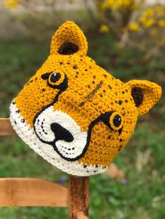 a crocheted hat with a tiger face on it