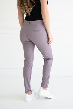 The Peggy Pant is Abendroth Golf’s signature product. It was designed by our founder and PGA Professional, Emily, to meet the need for the perfect women's golf pant. The Peggy Pant features a tapered leg and ankle zip, and includes five-pockets. Each pocket is big enough to store your phone, scorecard, keys, and any other essentials. One pocket has a zipper closure to keep valuables safe and secure. The Peggy Pant's feminine style combines function and professionalism, making it a versatile pant for on and off the course! Nylon/Spandex Blend Four-way stretch, sweat-wicking performance material High waisted, relaxed fit straight through the hip and thigh Tapered leg, fitted at the ankle with zip closure Machine wash cold, tumble dry or hang dry Athleisure Stretch Bottoms For Golf, Stretch Athleisure Bottoms For Golf, Sporty 4-way Stretch Pants For Golf, Fitted Athleisure Bottoms For Golf, 4-way Stretch Tapered Leg Golf Pants, 4-way Stretch Tapered Golf Pants, Fitted Tapered Leg Golf Pants, Golf Pants, S Signature