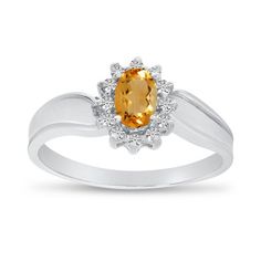 an oval shaped yellow sapphire and diamond ring in white gold with diamonds around the band