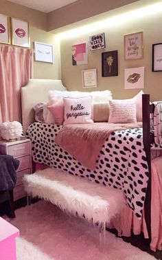 a bedroom with pink and black decor on the walls