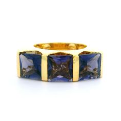 --Stone(s):-- (3) Natural Genuine Iolites - Square Step Cut - Channel Bar Set - Purplish Blue Color - 7mm (approx.) Material: Solid 18k Yellow Gold Weight: 12.20 Grams Ring Size: 5.5 (Fitted on a finger. We can custom size this ring - Please contact us prior to purchase for sizing inquiries) Top of Ring Dimensions: 7.3mm (0.29") (top of the ring at widest area - north to south), 24.5mm (0.96") (east to west), 4.9mm (bottom of the shank) Ring Height: 7.3mm rise off the finger Condition: Shows som Step Cut, Channel Set, Square Cut, Bar Set, Band Ring, Band Rings, Jewelry Watches, Jewelry Rings, Ring Size