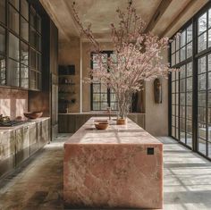 a kitchen with marble counter tops and large windows