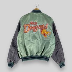 REMINDER: THIS IS USED CLOTHING PLEASE DO NOT EXPECTED IT LIKE TO BE NEW OR IN PRISTINE CONDITION Feel free to contact me for any question. I'll assist you with my pleasure. Vintage 1990s AVIREX Ltd Varsity Jacket Small Distressed Faded Avirex Gold Dragons Embroidery Logo Satin Baseball Bomber Style Jacket Size S *All measurements are taken with the garment flat on the ground. SIZE ON TAG :- Size S ACTUAL SIZE MEASUREMENT :- ARM PIT TO ARM PIT :- 23.5" inches BACK COLLAR TO HEM :- 25.5" inches C Gold Dragon, Baseball Jacket, Jacket Buttons, Used Clothing, Embroidery Logo, Knights, Varsity Jacket, Bathing Beauties, Jackets & Coats