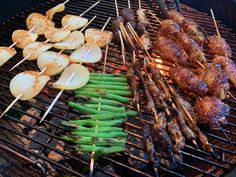 the food is being cooked on the grill with skewered potatoes and green beans