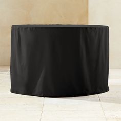 a black table cover sitting on top of a tiled floor