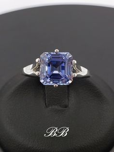 Made to order.  Please allow up to 3 weeks for production of your ring. This listing is for a 925 unplated sterling silver ring with a high quality lab created ceylon blue sapphire gemstone. Gem Type: Lab Created Sapphire Shape: Asscher Cut Size: 8mm Weight: 2.5 carats approximately Quality: AAA Hardness: 9 Mohs Available in the following Metal Options (all are unplated metals) 925 Sterling Silver 10kt White Gold (non-rhodium plated) 10kt Yellow Gold 14kt White Gold (non-rhodium plated) 14kt Yellow Gold 14kt Rose Gold Did you know lab-created sapphires are equivalent to natural sapphires? Lab grown sapphires have the same chemical composition as natural sapphires. They have the same refractive index (sparkle), specific gravity etc. They are made of corundum, the same thing mother nature ma Ceylon Blue Sapphire, Blue Sapphire Gemstone, Asscher Cut, Natural Sapphire, Denver Co, Sapphire Gemstone, Jewelry Plate, Matching Earrings, 3 Weeks