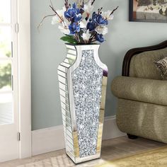 a white vase with blue flowers in it