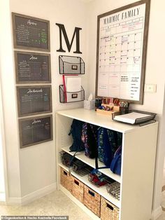 a white shelf filled with lots of items next to a chalkboard and calendar on the wall