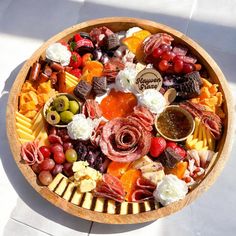 a wooden bowl filled with lots of different types of food