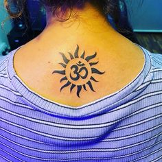 a woman with a tattoo on her neck that has the number thirty and sun in it