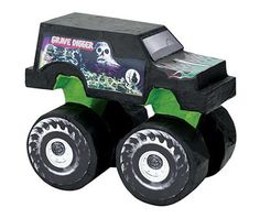 a black monster truck with green wheels and skulls on it