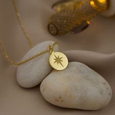 Navigate your style with our exquisite 14K Solid Gold North star Necklace. This celestial pendant embodies the spirit of exploration, guiding you through life's journeys with its radiant North star charm. Crafted with precision, this guiding star jewelry is a symbol of hope and direction, making it the perfect gift for the navigator in your life. Elegant and timeless, this nautical charm necklace adds a touch of maritime allure to any outfit. Whether you're setting sail on a new adventure or see Celestial Star-shaped Jewelry With Compass Design, Star-shaped Compass Necklace As Gift, Star-shaped Compass Necklace As A Gift, Star-shaped Compass Design Necklace For Gift, Star-shaped Compass Design Necklace As Gift, Star-shaped Compass Necklace Gift, Symbolic Gold Star Necklace, Spiritual Star-shaped Gold Jewelry, Star-shaped Engraved Necklace For Gift