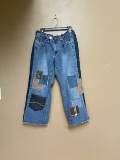 Reconstructed Baggy Patchwork Denim Capri Jeans  Stretch waist ( I added elastic inside waistband in back and sides ) I also added an extra button to adjust & personalize fit  Fits size 14 women's  13" measured across thigh 24" across back of hips  24" inseam 35" long measured from top of waist band to Raw hem Recycled Denim Wide Leg Bottoms For Fall, Casual Wide Leg Patchwork Jeans, Casual Straight Leg Patchwork Jeans, High Rise Stretch Jeans With Patchwork, High Rise Patchwork Bottoms In Medium Wash, High Rise Medium Wash Patchwork Bottoms, Stretch High Rise Jeans With Patchwork, Medium Wash Mid-rise Bottoms With Patchwork, Medium Wash High Rise Patchwork Bottoms