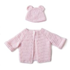 a pink knitted cardigan and hat for a baby girl on a white background