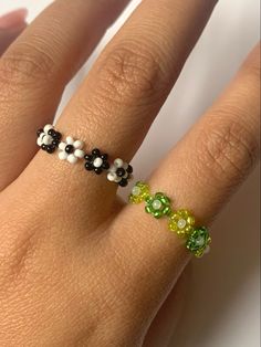 a woman's hand with two different colored rings on top of her ring finger