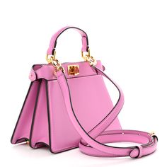 This is an authentic FENDI Shiny Nappa Petite Peekaboo I SEE U Satchel in Rosa. This chic tote is finely crafted of smooth padded calfskin leather in pink. This mini-sized bag features a leather top handle, adjustable, optional leather shoulder strap with gold hardware including squared turn locks on either side. This opens to reveal a leather interior with a patch pocket. Fendi Peekaboo Bag, Pokemon Fabric, Fendi Shoulder Bag, Fendi Peekaboo, Phone Pouch, Shopper Tote, Fendi Bags, Green Bag, Leather Interior