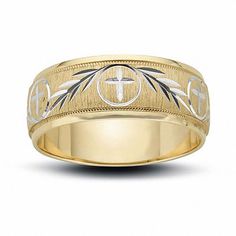 a gold wedding ring with cross and wings